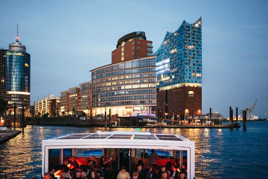 Hamburg: 1-Hour Harbor Evening Lights Cruise - Speicherstadt canals after dark, illuminated warehouses that look unreal in reflections